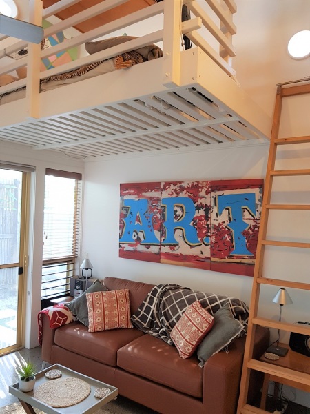 The loft lounge with mezzanine bed above